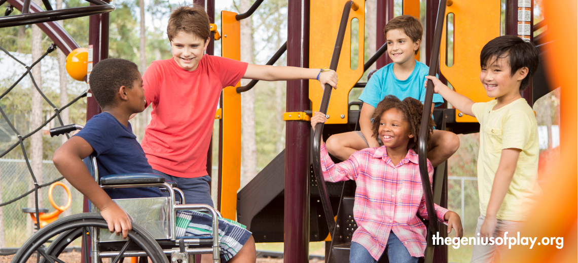 Multi ethnic group of children including one in wheelchair smiling together standing near a school bus. 