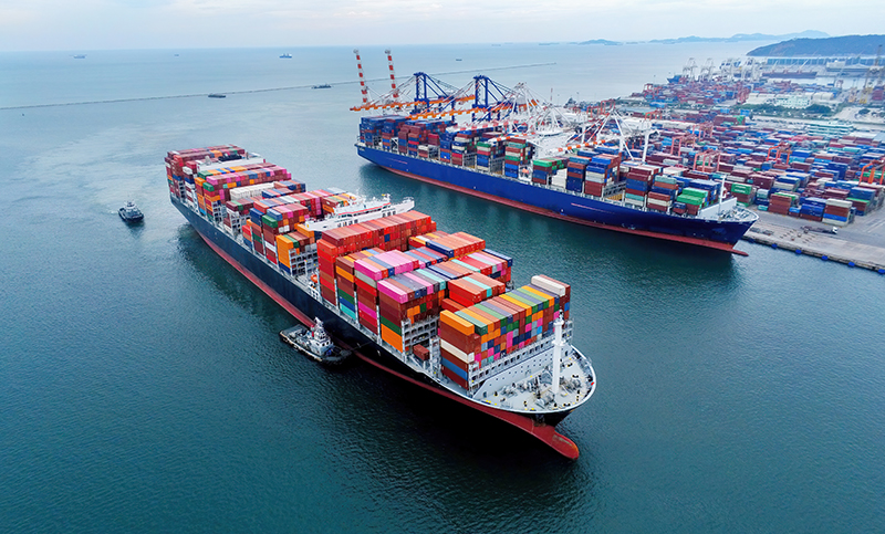 stock image of shipping containers at sea